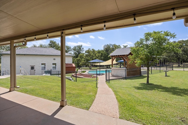 view of yard with a fenced in pool and a patio area