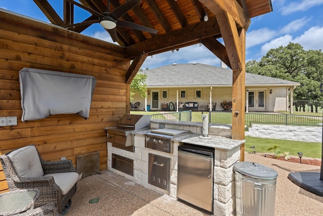 view of patio with area for grilling and ceiling fan