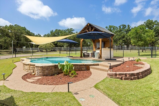 view of swimming pool featuring a lawn, ceiling fan, and a patio