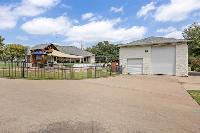 view of property exterior featuring a lawn, a garage, and an outbuilding