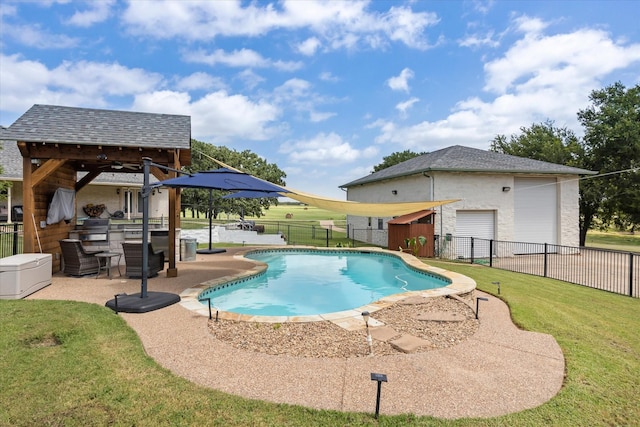 view of pool featuring an outdoor kitchen, a lawn, a patio, and exterior bar