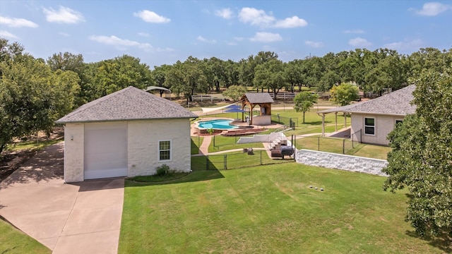 view of yard featuring a garage and an outbuilding