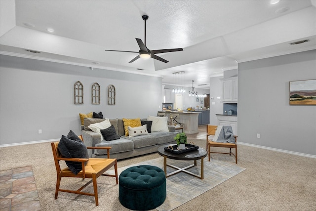 living room with light colored carpet and ceiling fan with notable chandelier