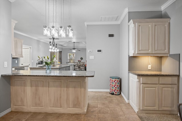 kitchen with kitchen peninsula, ceiling fan with notable chandelier, stone countertops, and decorative light fixtures