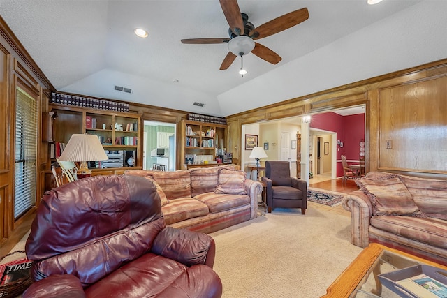 carpeted living room featuring ceiling fan, a textured ceiling, and vaulted ceiling