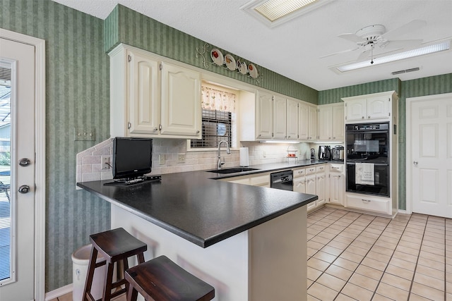 kitchen featuring black appliances, white cabinets, kitchen peninsula, and sink