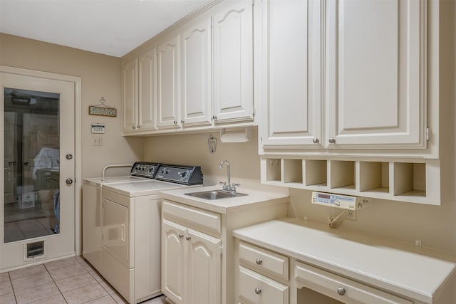 laundry room with independent washer and dryer, cabinets, light tile patterned floors, and sink