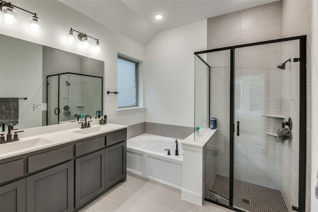 bathroom featuring vanity, lofted ceiling, and separate shower and tub