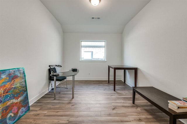 sitting room with vaulted ceiling and hardwood / wood-style floors