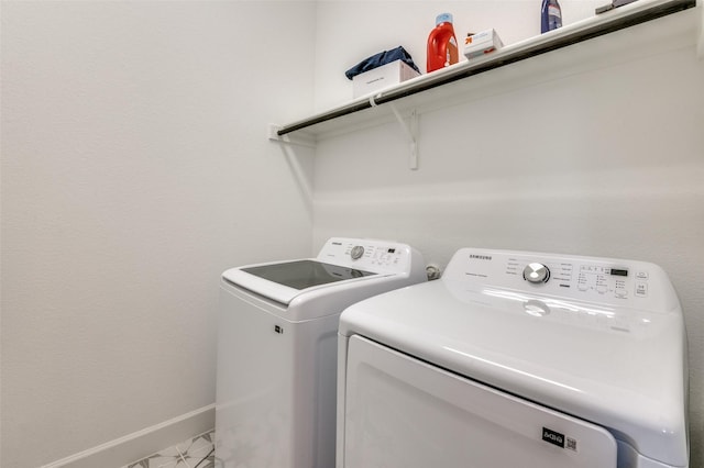 laundry room with separate washer and dryer and tile patterned flooring