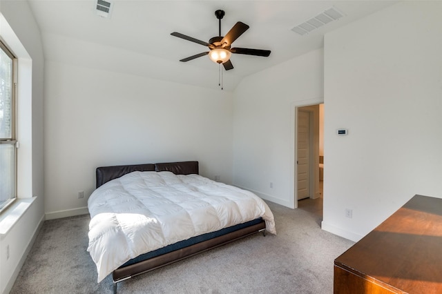 carpeted bedroom with vaulted ceiling and ceiling fan