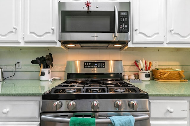 kitchen with white cabinets, decorative backsplash, and appliances with stainless steel finishes