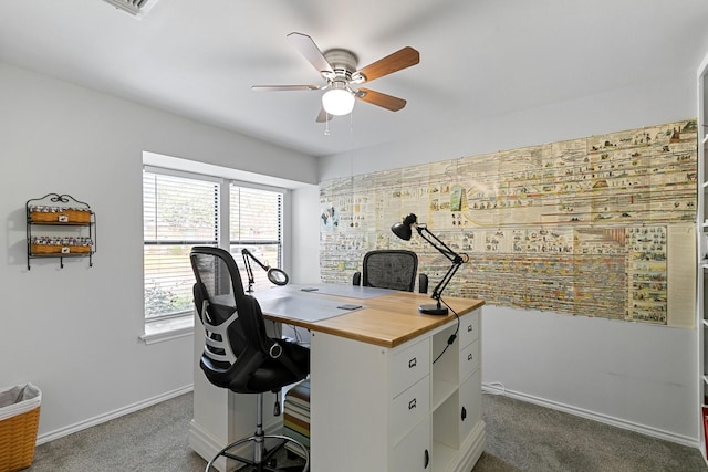 office with dark colored carpet and ceiling fan