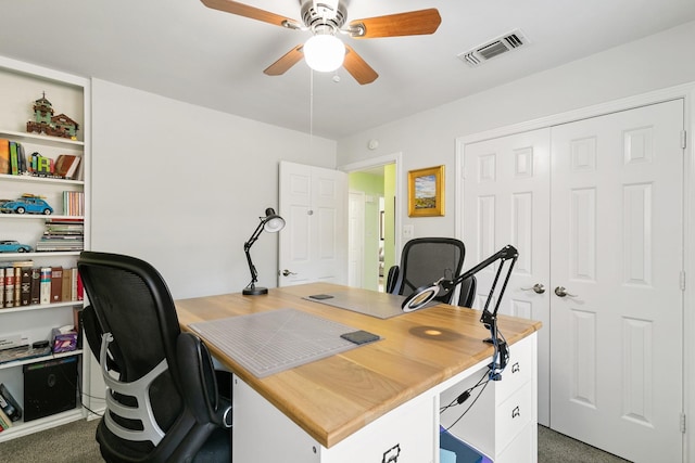 carpeted office featuring ceiling fan