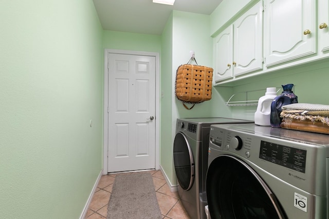 washroom featuring light tile patterned flooring, cabinets, and independent washer and dryer