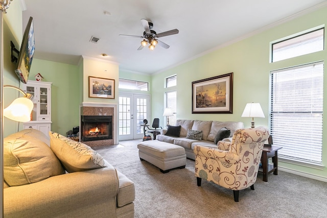 carpeted living room featuring ceiling fan and ornamental molding