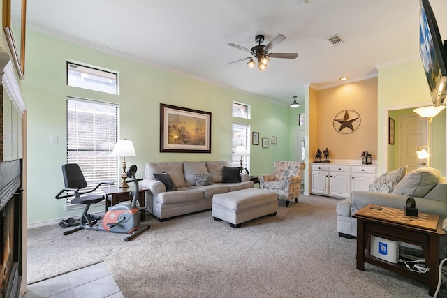 living room featuring light carpet, ceiling fan, and ornamental molding