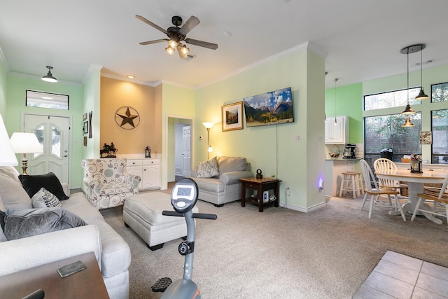 carpeted living room featuring ceiling fan and ornamental molding