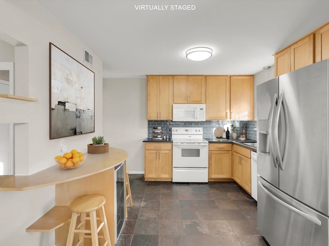 kitchen with range with electric stovetop, stainless steel fridge with ice dispenser, and light brown cabinets