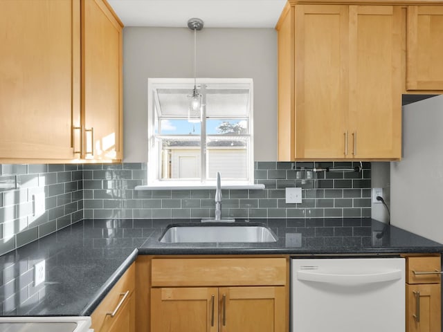 kitchen featuring backsplash, sink, white dishwasher, and hanging light fixtures