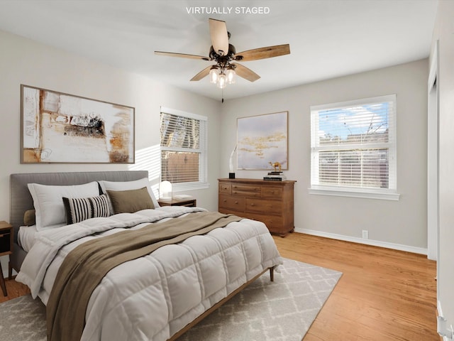 bedroom featuring light hardwood / wood-style floors and ceiling fan