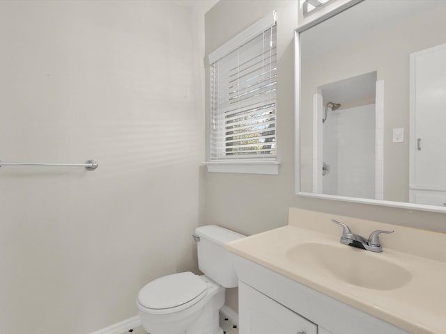 bathroom with vanity, toilet, and walk in shower