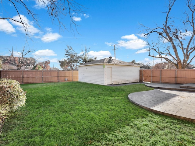 view of yard featuring an outbuilding and a patio area