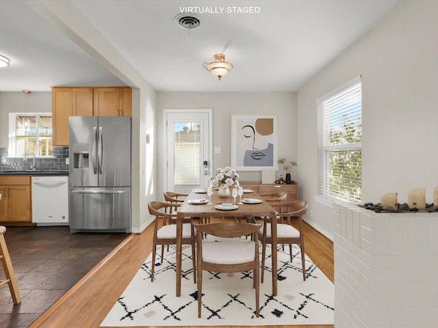 dining area with dark hardwood / wood-style flooring and sink