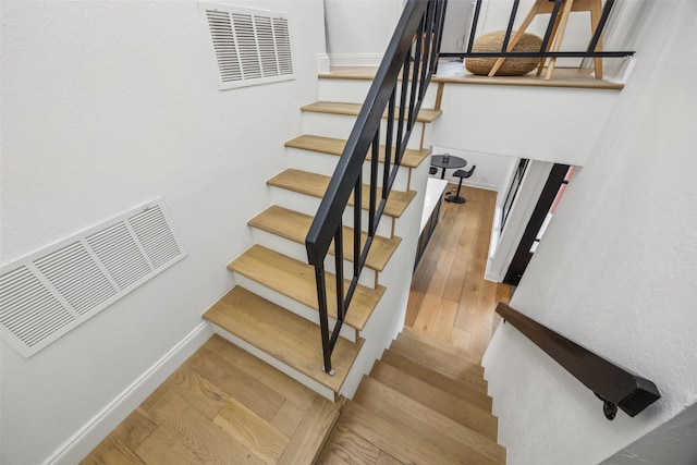 stairway featuring wood-type flooring