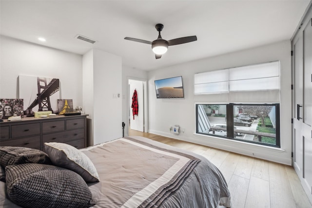 bedroom with ceiling fan and light hardwood / wood-style flooring