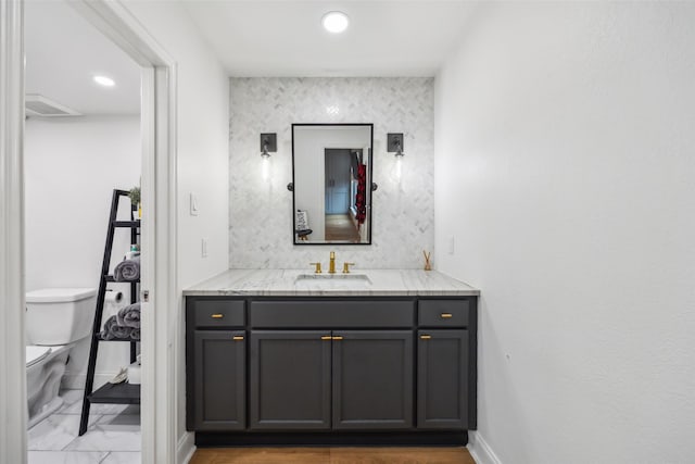 bathroom featuring toilet and vanity