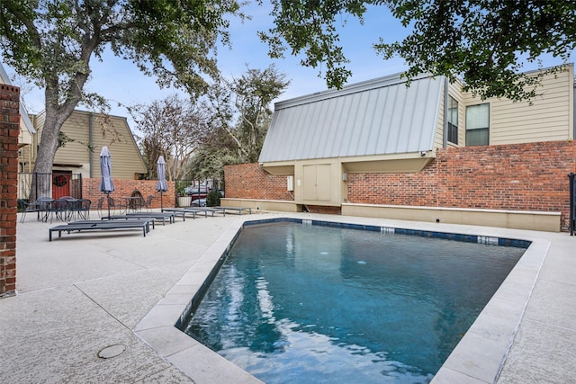 view of swimming pool featuring a patio area