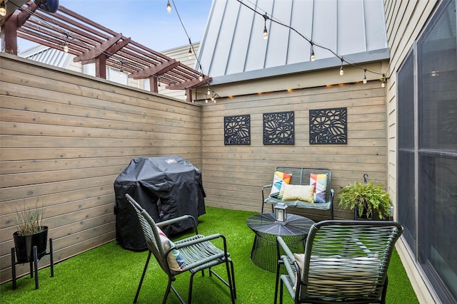 view of patio with a grill and a pergola