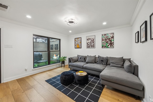 living room featuring ornamental molding and hardwood / wood-style flooring