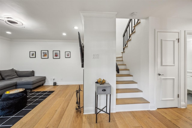 living room featuring hardwood / wood-style floors and crown molding