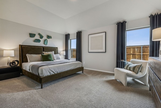 bedroom with carpet, multiple windows, and lofted ceiling