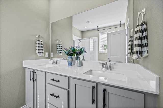 bathroom featuring vanity and a shower with shower door