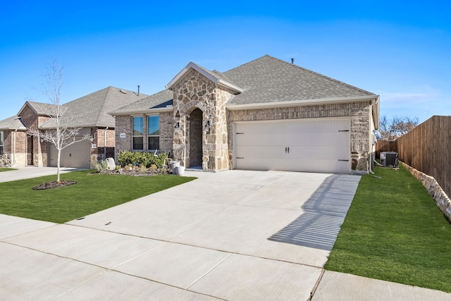 view of front facade featuring central AC, a garage, and a front lawn