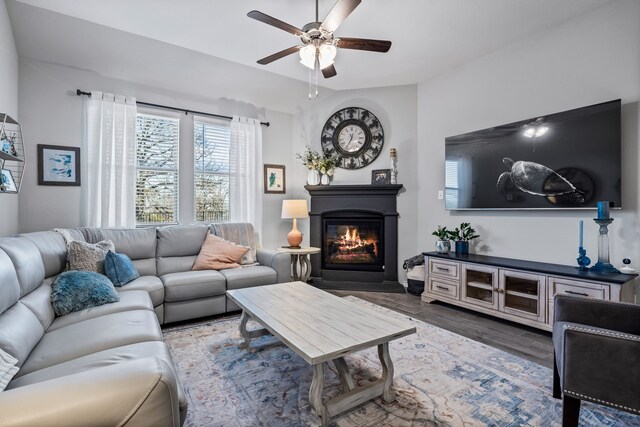 living room with dark hardwood / wood-style flooring, vaulted ceiling, and ceiling fan