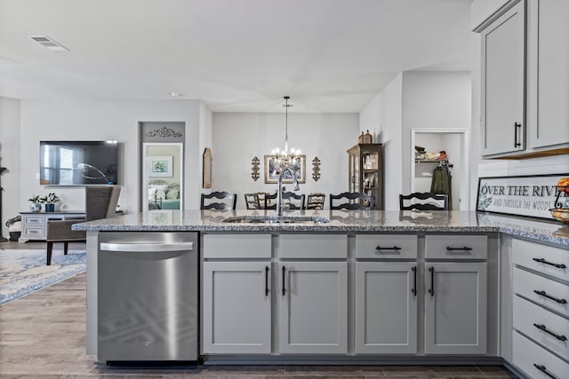 kitchen featuring gray cabinetry, dishwasher, sink, an inviting chandelier, and decorative light fixtures