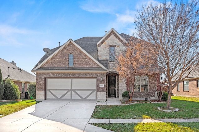 view of front of home with a front yard and a garage