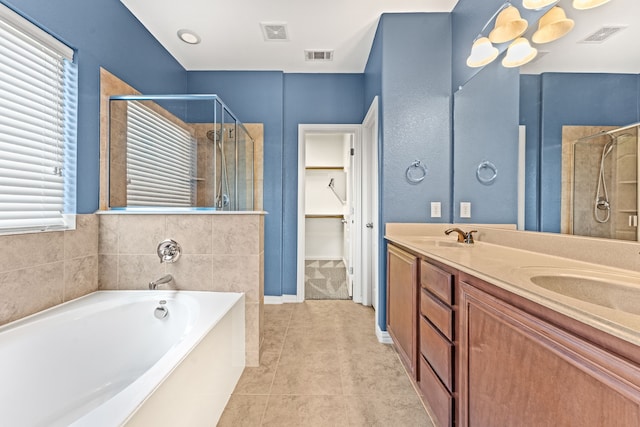 bathroom featuring tile patterned floors, vanity, and shower with separate bathtub