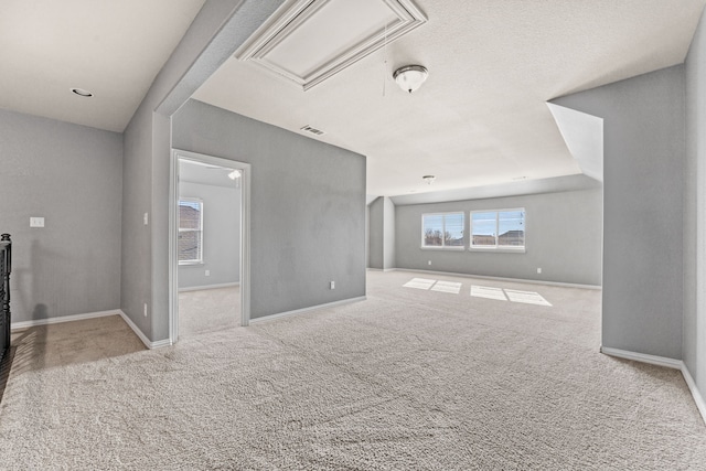 unfurnished living room featuring light carpet