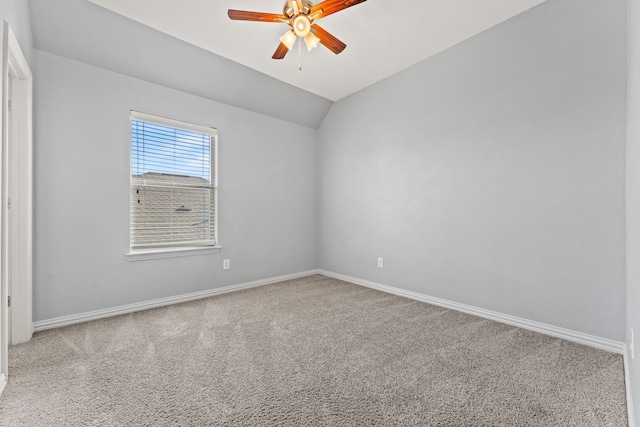 carpeted spare room featuring ceiling fan and lofted ceiling