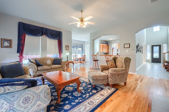 living room featuring ceiling fan and light wood-type flooring