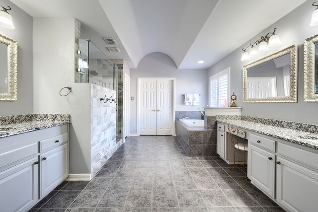 bathroom with vanity, lofted ceiling, and plus walk in shower