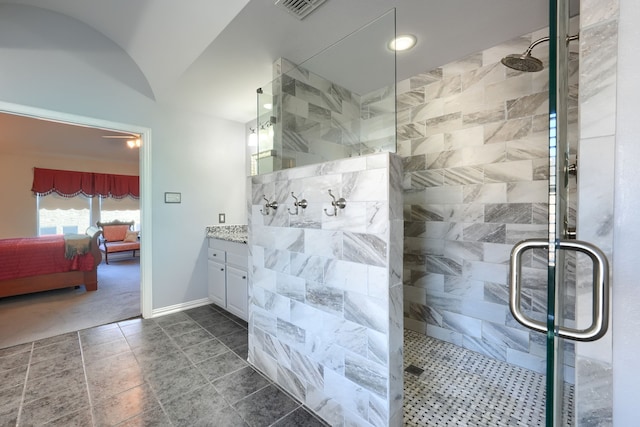 bathroom featuring vanity, a shower with door, and vaulted ceiling