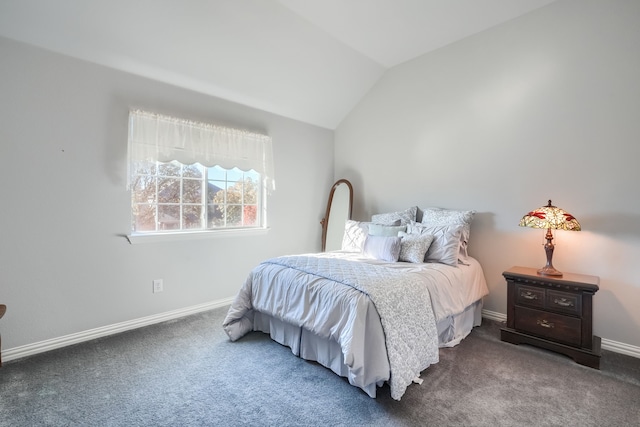 bedroom with dark carpet and lofted ceiling