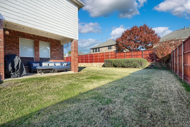 view of yard with an outdoor living space and a patio