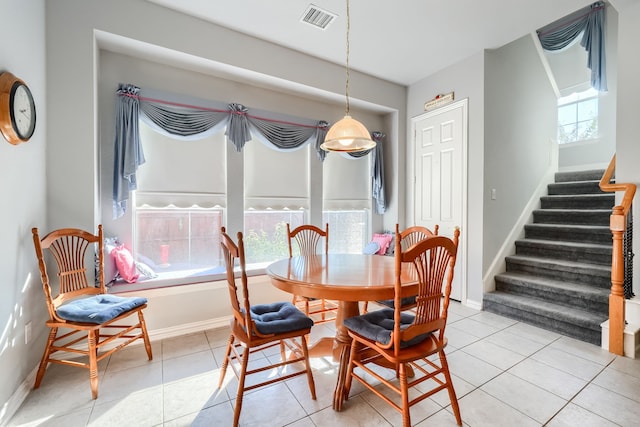 dining space featuring light tile patterned floors and a wealth of natural light